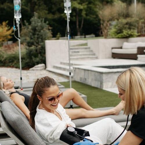 woman getting her blood pressure checked, by the pool