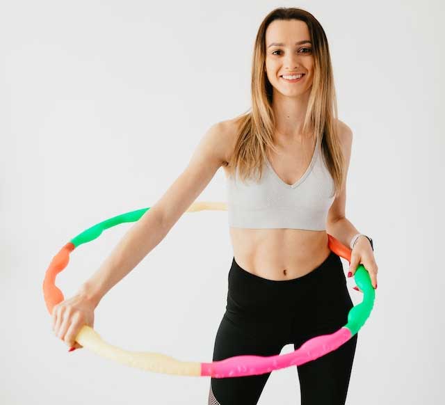 Woman with a Hula hoop, smiling, happy