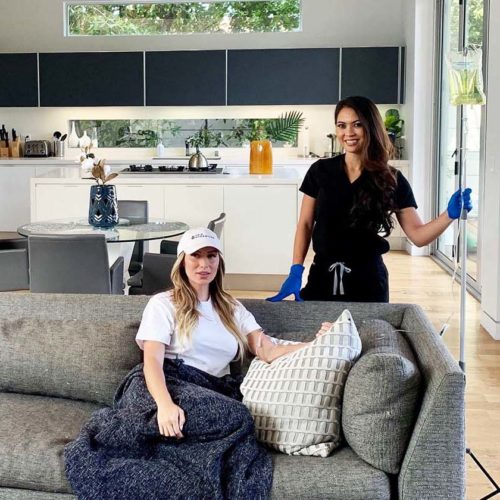 woman receiving IV at her home with the nurse beside her