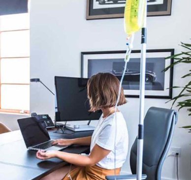 Girl Receiving On Demand IV Therapy in her Office from DripHydration