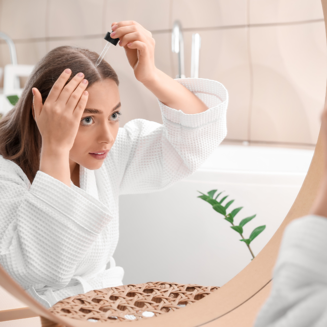 A woman in a bathrobe combing her hair